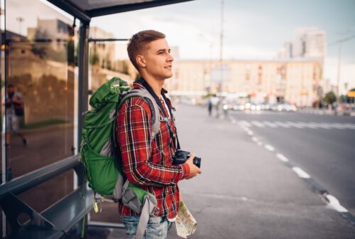 Male tourist with backpack at bus stop 2021 08 26 16 26 51 utc 1